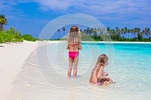 Adorable little girls having fun during beach