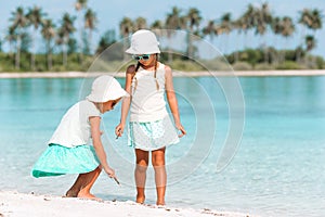 Adorable little girls having fun during beach vacation