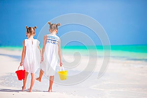 Adorable little girls having fun during beach vacation