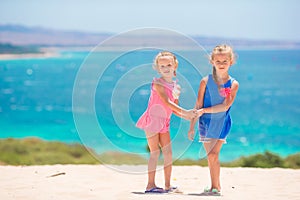 Adorable little girls having fun during beach vacation