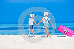 Adorable little girls having fun during beach vacation