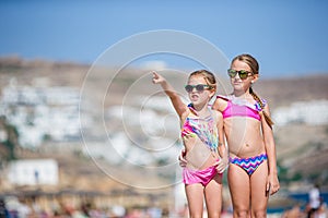 Adorable little girls having fun during beach vacation. photo