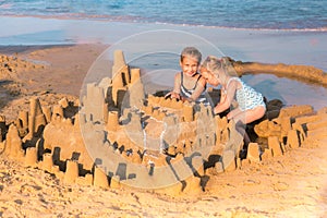 Adorable little girls playing at the seashore