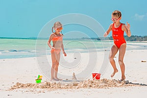 Adorable little girls during summer vacation on the beach