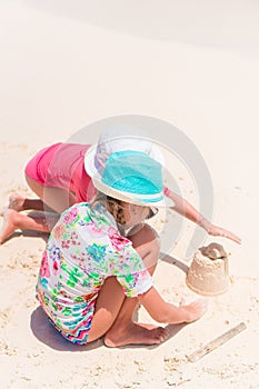 Adorable little girls during summer vacation on the beach