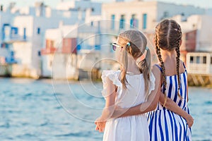 Adorable little girls on vacation on Mykonos island, Greece.