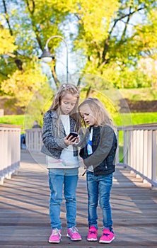 Adorable little girls at warm autumn day outdoors