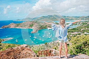 Adorable little kid enjoying the view of picturesque English Harbour at Antigua in caribbean sea