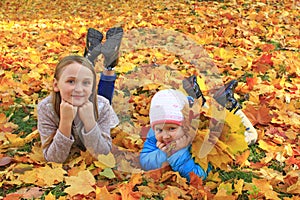 Adorable little kids playing in autumn park. Children in park