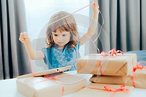 Adorable Little Toddler Girl Opening Presents for her Birthday