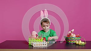 Adorable little youngster creates handcrafted ornaments for Easter Sunday