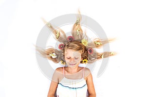 Adorable long haired child with floral decoration shot from birds perspective