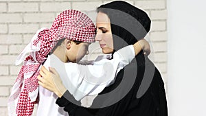 Adorable middle eastern woman playing with her son at home