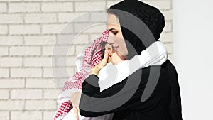 Adorable middle eastern woman playing with her son at home