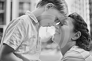 Adorable mother and son smiling happy having fun at city background. Motherhood