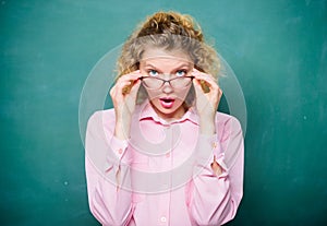 Adorable nerd. Woman school teacher shy and pretty lady wear eyeglasses chalkboard background. Sexy teacher concept