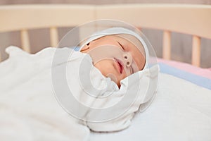 adorable new born baby sleeping in bed