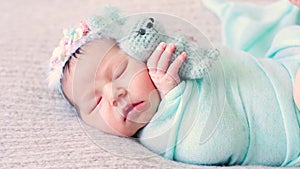 Adorable newborn lies on bed with favorite plush toy