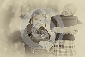 Two little girls ready back to school closeup, autumn day.