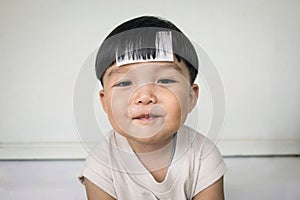 Adorable plump boy smilingly with chubby cheeked photo