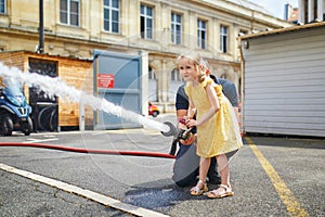 Adorable preschooler girl acting like a fireman