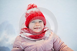 Adorable preschooler girl having fun in beautiful winter park on a snowy cold winter day