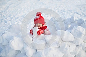 Adorable preschooler girl having fun in beautiful winter park on a snowy cold winter day