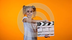 Adorable preteen girl clapping flapper pretending to be film producer, dream