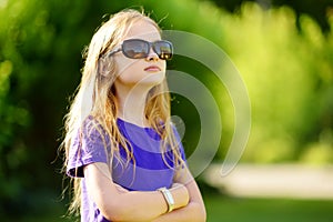 Adorable preteen girl wearing sunglasses on sunny summer day