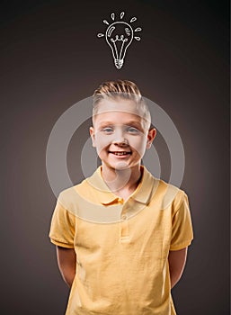 adorable preteen smiling boy with drawn light bulb idea,