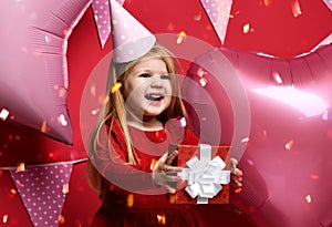 Adorable pretty girl with pink balloons and red present gift and birthday cap