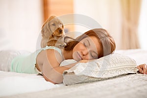 Adorable puppy wake young girl in the morning