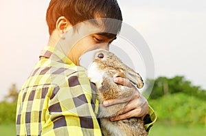 adorable rabbit being hugged by a man