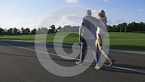 Adorable senior couple on a stoll in park