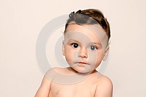 Adorable six month old child looking at camera.