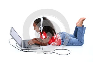 Adorable Six Year Old Girl Sitting On Floor With Laptop Computer photo