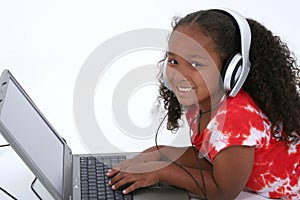 Adorable Six Year Old Girl Sitting On Floor With Laptop Computer