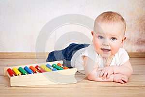 Adorable smiling baby boy crawling on the floor