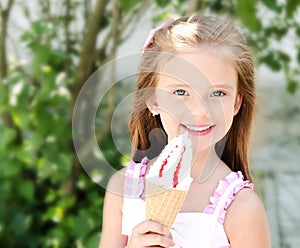 Adorable smiling little girl eating ice cream