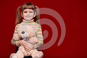 Adorable smiling little girl hold teddy bear