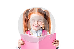 Adorable smiling schoolgirl reading textbook