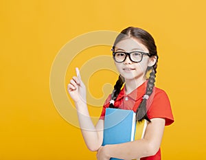 Adorable student girl  holding the books  and showing something