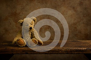 Adorable stuffed bear on wooden shelf