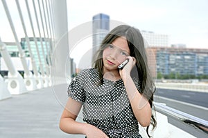 Adorable teenager little girl talking phone