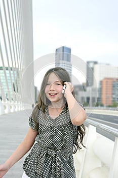 Adorable teenager little girl talking phone