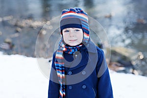 Adorable toddler boy on beautiful winter day