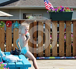 Adorable Toddler Boy eating a Popsicle by the Pool