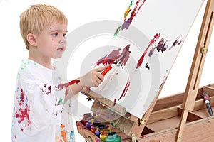Adorable Toddler Boy Painting at Easel