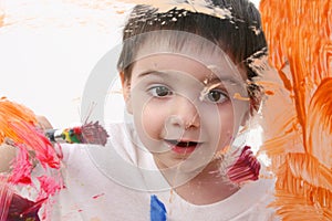 Adorable Toddler Boy Painting On Glass