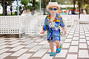 Adorable toddler boy in summer holiday resort in Mauritius, casually dressed